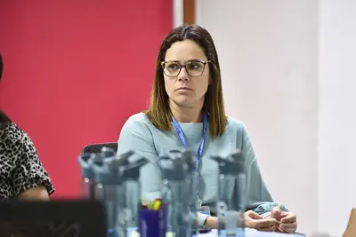 Diretora do Departamento de Apoio aos Juizados Especiais (Daje), Shusiene Tassinari Machado é uma mulher branca, com cabelos loiros até os ombros, usa óculos e camisa azul