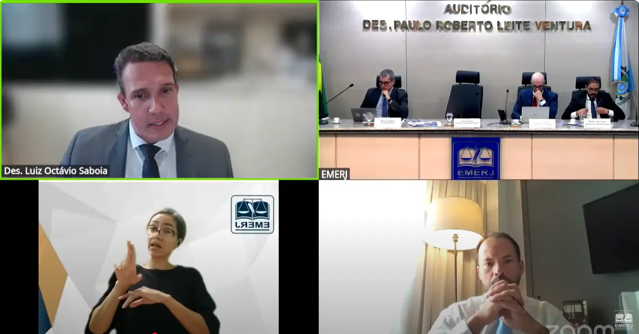 Print de tela que mostra uma videoconferência dividida em quatro quadros. Em um deles, aparece o desembargador Luiz Octávio Saboia falando.